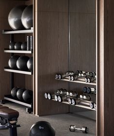 there is a gym room with various exercise equipment in it, including kettles and dumbbells