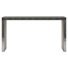 a table that is made out of metal and has a diamond pattern on the top