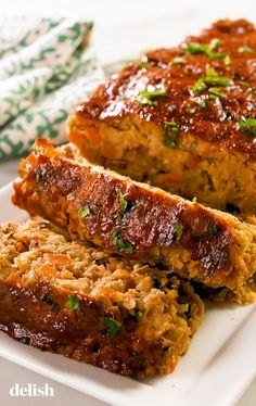 meatloaf with sauce and herbs on a white plate