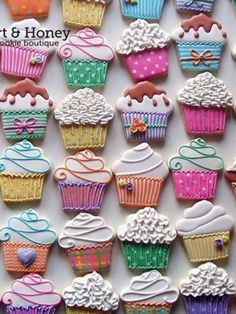 many decorated cupcakes are displayed on a white surface with the words art & honey