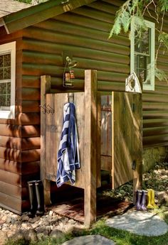 there is a small cabin in the woods with clothes hanging out to dry on it