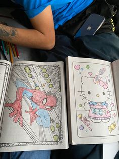 two children's coloring books with hello kitty and spiderman on them, laying next to each other