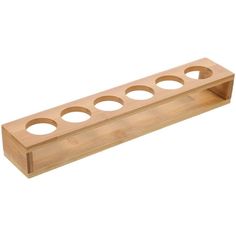 a wooden shelf with six holes in it