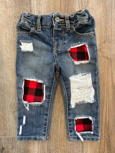 Distressed Infant/Toddler Jeans with Black and Red Checkers. May select from black denim or blue denim jeans. All black denim are skinny jeans. Wash color of denim may vary based on style selected. Distress and patch sizes to jeans may vary based on size ordered. All jeans have adjustable waists. In order to maintain longevity wash items on a cold delicate cycle and tumble dry. May also hand wash and lay flat to dry. Due to each order being fully customized we do not offer returns or refunds. Casual Jeans With Patches For Fall, Casual Patched Jeans For Fall, Trendy Plaid Cotton Jeans, Winter Distressed Cotton Jeans, Trendy Plaid Jeans For Fall, Black And Red Checkered, Plaid Jeans, Toddler Jeans, All Jeans