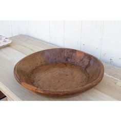 a wooden bowl sitting on top of a table