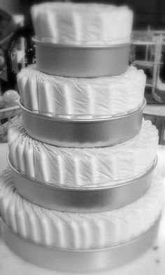 a stack of white diaper cakes sitting on top of a table