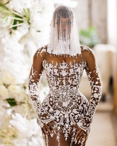 a woman in a white wedding dress and veil