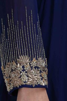 the back of a woman's dress with gold beading and sequins