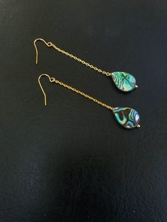 These beautiful earrings are made from real abalone shell. These abalone earrings are durable, lightweight and very elegant. They will make a perfect gift for someone special in your life or just because you deserve it. Each shell is unique, therefore, please expect a small variety from the shell on the photographs. The French ear wires on these earrings and dainty chain filled with 18k gold. Each item is carefully packaged in an elegant jewelry box ready as a gift. If you would like to add a pe Abalone Shell Drop Earrings, Elegant Teardrop Abalone Shell Earrings, Elegant Abalone Shell Teardrop Earrings, Gold Abalone Shell Earrings For Gifts, Teardrop Abalone Shell Jewelry With Matching Earrings, Mop Jewelry, Teardrop Bridal Earrings, Abalone Jewelry, Formal Earrings