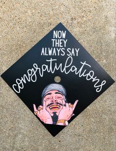 a black graduation cap with an image of a man holding his hand up to his face