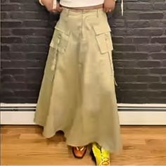 This Is An Urban Revivo Tan/Olive Cargo Skirt With Working Side And Cargo Pockets. It Has An Elastic Waistband In The Back For Comfort. The Skirt Is Filled With And Comes To My Ankles (I Am 5’4” For Reference). The Waist Runs Small Even Though It Says It’s An Xl. Please Keep That In Mind If You Wish To Purchase. The Closure Is A Zippered Fly With Silver Button. High Waist Khaki Cotton Skirt, High Waist Beige Cargo Skirt For Spring, High-waist Beige Cargo Skirt For Spring, High Waist Khaki Skirt For Spring, High Waist Khaki Cargo Skirt For Spring, Summer Khaki Cargo Skirt, Khaki Wide Leg Skirt With Pockets, Spring Cargo Skirt With Cargo Pockets, Khaki Long Skirt With Pockets