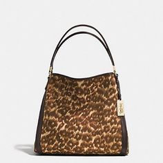 Stylish Coach Madison Ocelot Phoebe Shoulder Bag. Outside Is Ocelot Print Fabric With Brown Leather Straps, Trim, And Bottom. Inside Is A Matching Brown Fabric. There Are 2 Side Compartments And One Center Zippered Compartment. One Side Compartment Has A Zippered Pocket, And The Other Has 2 Slip Pockets. This Bag Has No Stains Or Tears Outside And Is Very Clean Inside. Shows Only Minor Signs Of Use. Details: * Ocelot Print Fabric With Leather Trim * Inside Zip, Cell Phone And Multifunction Pockets * Center Zip Compartment * Magnetic Snap Closures, Fabric Lining * Handles With 11" Drop * 13 1/2" (L) X 11 1/2" (H) X 5 3/4" (W) Leopard Print Tote Shoulder Bag With Gold-tone Hardware, Elegant Leopard Print Bag With Double Handle, Tortoiseshell Bags For Everyday Use, Leopard Print Bag With Gold-tone Hardware And Top Handle, Leopard Print Bags With Gold-tone Hardware For Shopping, Leopard Print Top Handle Bag With Gold-tone Hardware, Elegant Bag With Leopard Print And Gold-tone Hardware, Elegant Leopard Print Bag With Gold-tone Hardware, Elegant Leopard Print Bag With Detachable Strap