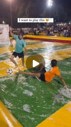 two people are playing soccer in the water