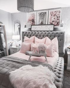 a bedroom with pink and grey decor, fur rugs and pictures on the wall