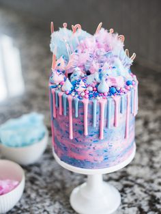 there is a cake with blue and pink icing on it