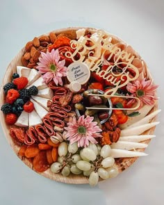 a platter filled with fruit, cheese and crackers that say happy new year