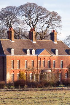 an old brick building with chimneys and windows