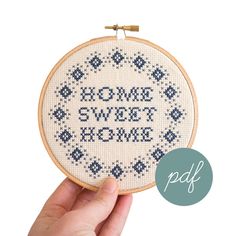 someone is holding up a cross - stitch pattern with the words'come sweet home'on it