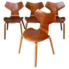 four wooden chairs sitting next to each other