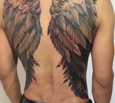 the back of a man with an angel tattoo on his chest