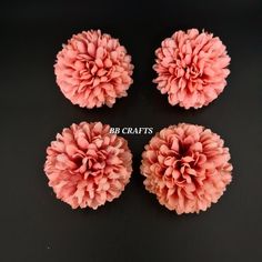 four pink flowers are shown on a black surface with the words bb crafts above them