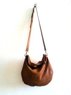 large brown leather bag .soft leatherThis bag is so comfortableand and versatile you can use it as a shoulder bag ,and cross body bag *   long adjustable strap attached*  Closed with metal zipper*  One zipper pocket inside*  2 open pocket inside*  Flat figure*  Italian leather* cotton liningApprox. dimensions: 14" x 16" incSee for more bags and purses here:http://www.etsy.com/shop/Smadars?ref=pr_shop_more**** A small surprise waiting for anyone who buys more than one item ***** Leather Gifts For Her, Brown Leather Crossbody Purse, Bag Packs, Cross Shoulder Bags, Brown Leather Backpack, Laptop Shoulder Bag, Bags And Purses, Brown Leather Totes, Black Leather Backpack