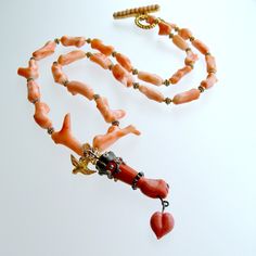 Coral Branch Necklace Removable Hand and Heart Coral Lampwork Figa Pen – Karen Sugarman Designs Elegant Adjustable Coral Necklace, Elegant Coral Necklace With Lobster Clasp, Coral Branch Necklace, Elegant Hand-strung Coral Necklaces, Belle Necklace, Multi-strand Coral Necklace For Gift, Heart Lamp, Byzantine Cross, Feminine Necklace