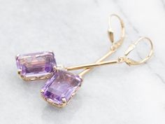 These elegant and luminous earrings feature yellow gold and amethyst set with a diamond accent, making it perfect for making a statement. Amethyst is known for its strength and protection properties, while the diamond accents provide the perfect touch of glam.Metal: 14K Yellow GoldGem: 2 Amethyst totaling 12.25 CaratsGem Measurements: 10.1 x 13.8 mm, Emerald CutAccents: 2 Diamonds totaling .10 Carats, SI in Clarity, G in ColorMeasurements: 10.1 x 54.3 mmMarks: "14KS" Stamped on the findings Amethyst Earrings Fine Jewelry For Formal Occasions, Amethyst Gemstone Earrings For Formal Occasions, Formal Amethyst Gemstone Earrings, Elegant Lavender Earrings With Gemstone Accents, Fine Jewelry Amethyst Earrings With Gemstone Accents, Elegant Purple 14k Gold Earrings, Lavender Fine Jewelry Earrings For Formal Occasions, Formal Lavender Fine Jewelry Earrings, Formal Lavender Amethyst Earrings