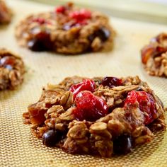 granola cookies with cherries and chocolate chips on a baking sheet