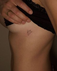 a woman with a butterfly tattoo on her stomach