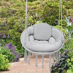 a hanging chair in the middle of a garden