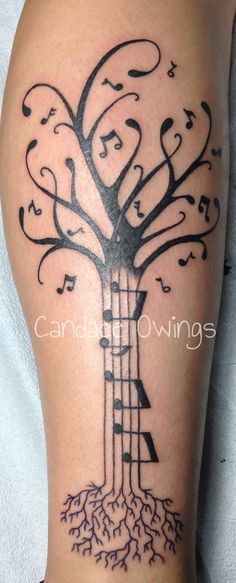 a tree with musical notes on it and roots growing out of the bottom half of its leg