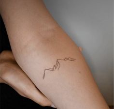 a woman's arm with a tattoo on it that has an arrow in the middle