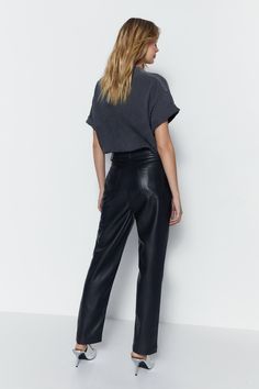 High-waisted fit with straight leg silhouette 
 Smooth faux leather fabric with a glossy finish 
 Flattering panel detailing and tailored shape 
 Versatile styling - dress up or down 
Showcase your figure in these straight leg faux leather trousers from Warehouse. Crafted from smooth vegan leather with a high-shine finish, these trousers feature a flattering high-waisted fit with belt loops and side pockets. The straight silhouette skims the body in all the right places while the supple faux leather fabric flatters your shape. Dress these trousers up with a graphic tee and pointed-toe heels for a night out, or style them casually with a t-shirt and trainers for daytime wear. Their sleek look makes them ideal for both smart and relaxed occasions. These versatile trousers easily transitio Faux Leather Trousers, Shape Dress, Party Skirt, Floral Outfit, Feather Dress, Puff Sleeve Dresses, Faux Leather Fabric, Tshirt Skirt, Leather Trousers