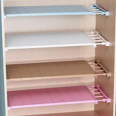 the shelves have pink and white boxes on them