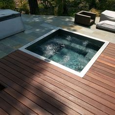 a hot tub sitting on top of a wooden deck