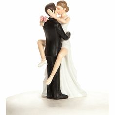 a figurine of a bride and groom holding each other in their arms, on a white background