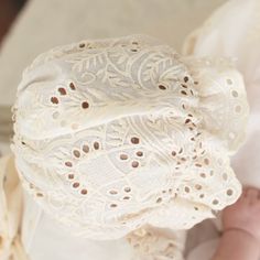 Handmade in the USA The Ingrid Lace Bonnet is a beautiful compliment to our Ingrid Christening Gown! Crafted with a 100% cotton lace in light ivory and a natural champagne tone. This lovely material has a vintage look we love! The back of the bonnet buttons for a unique detail. Designed to create sweet lace ruffles that frame her face. Champagne cotton ribbons ties complete the design. 100% cotton 100% cotton ribbon ties Shell button back Beige Scalloped Lace For Spring, White Crochet Lace In Feminine Style, White Crochet Lace With Feminine Style, Beige Crochet Lace For Spring, Spring Beige Crochet Lace, Feminine Cream Lace For Wedding, Beige Crochet Lace For Summer, Elegant Cream Lace For Summer, Feminine Cream Lace With Lace Trim