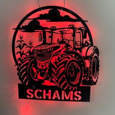 a lighted sign with a tractor in the middle and schams on it's side