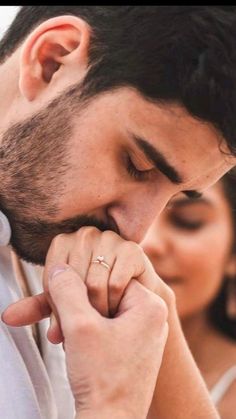 a close up of a person holding their hand to his face with the other hand