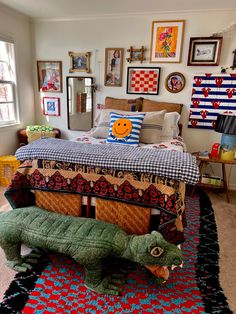 a bedroom with an alligator bed in the middle and pictures on the wall above it