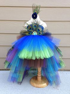 a dress made out of tulle and peacock feathers