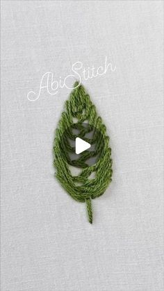 the video shows how to crochet an acorn stitch