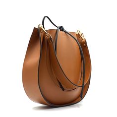 Introducing an original leather bag. With its sleek design and large size, it fits all your essentials. Inside, there"s one large compartment.  Made of high-quality italian leather. Close with leather ties.  Size: 29x28x8 cm (11,4x11x3,15 inches)  Belt Length: 60cm (23,6 inch) Hardware is gold.  If your like this bag, but want nodifications, please let me know. I can customize the size or color for you. Feel free to ask any questions. Leather Bucket Bag With Smooth Grain For Office, Versatile Leather Shoulder Bag With Smooth Grain, Versatile Cognac Shoulder Bag With Smooth Grain, Luxury Saddle Shoulder Bag For Everyday Use, Office Tote Bucket Bag With Smooth Grain, Modern Saddle Leather Bag, Office Bucket Bag With Smooth Grain In Tote Style, Cognac Smooth Grain Versatile Shoulder Bag, Calf Leather Bags In Cognac For Everyday Use