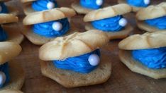 some cookies with blue icing and white frosting on them