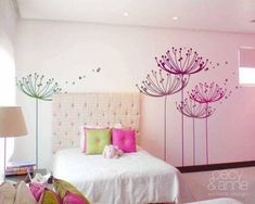 a bedroom with pink and green decor on the walls