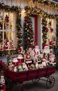 a wagon full of christmas decorations in front of a house with santas on it