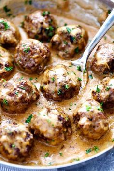 a skillet filled with meatballs and gravy