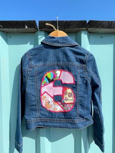 **NEW LAUNCH** A sweet little embroidered denim jacket personalised with your little ones age. FREE UK DELIVERY Preloved Jacket. Thread colour for number can be fuschia pink, pale pink, orange, blue, yellow, green or gold. Please specify upon ordering. Jackets are all second hand good condition and mid blue denim. Brand of jacket will be either Gap, Next, Fatface, Mantaray or M and S. Blue Denim Outerwear With Custom Embroidery, Fitted Denim Jacket With Embroidered Patch And Long Sleeves, Custom Embroidered Long Sleeve Denim Jacket, Fitted Denim Jacket With Custom Embroidery, Number Outline, Yellow Lilac, Upcycled Denim Jacket, Personalized Jacket, Kids Jackets