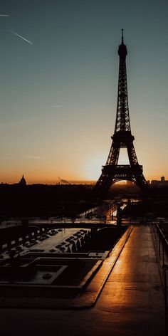 the eiffel tower is lit up at night